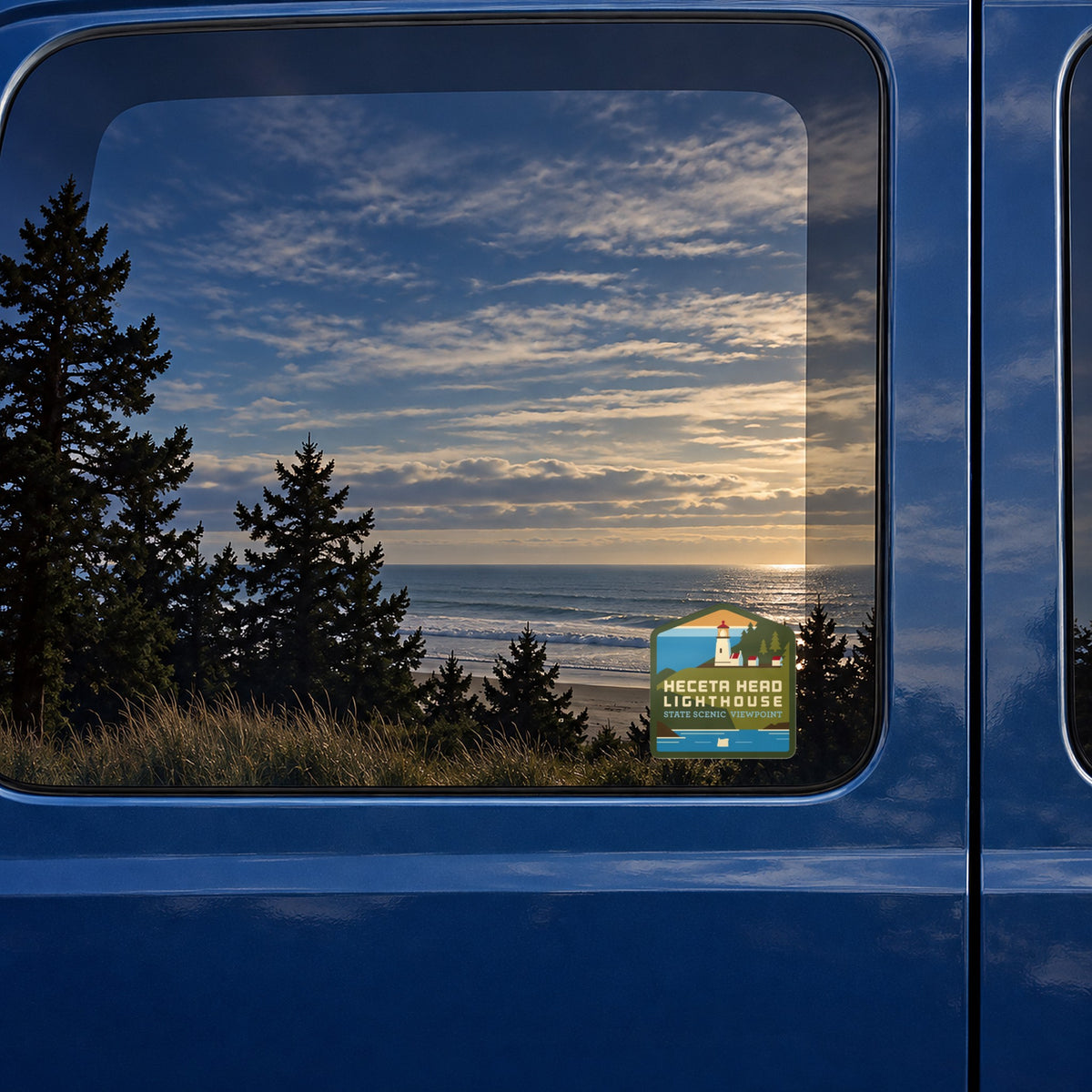 Heceta Head sticker on the rear window of a van, reflecting a beach at sunset