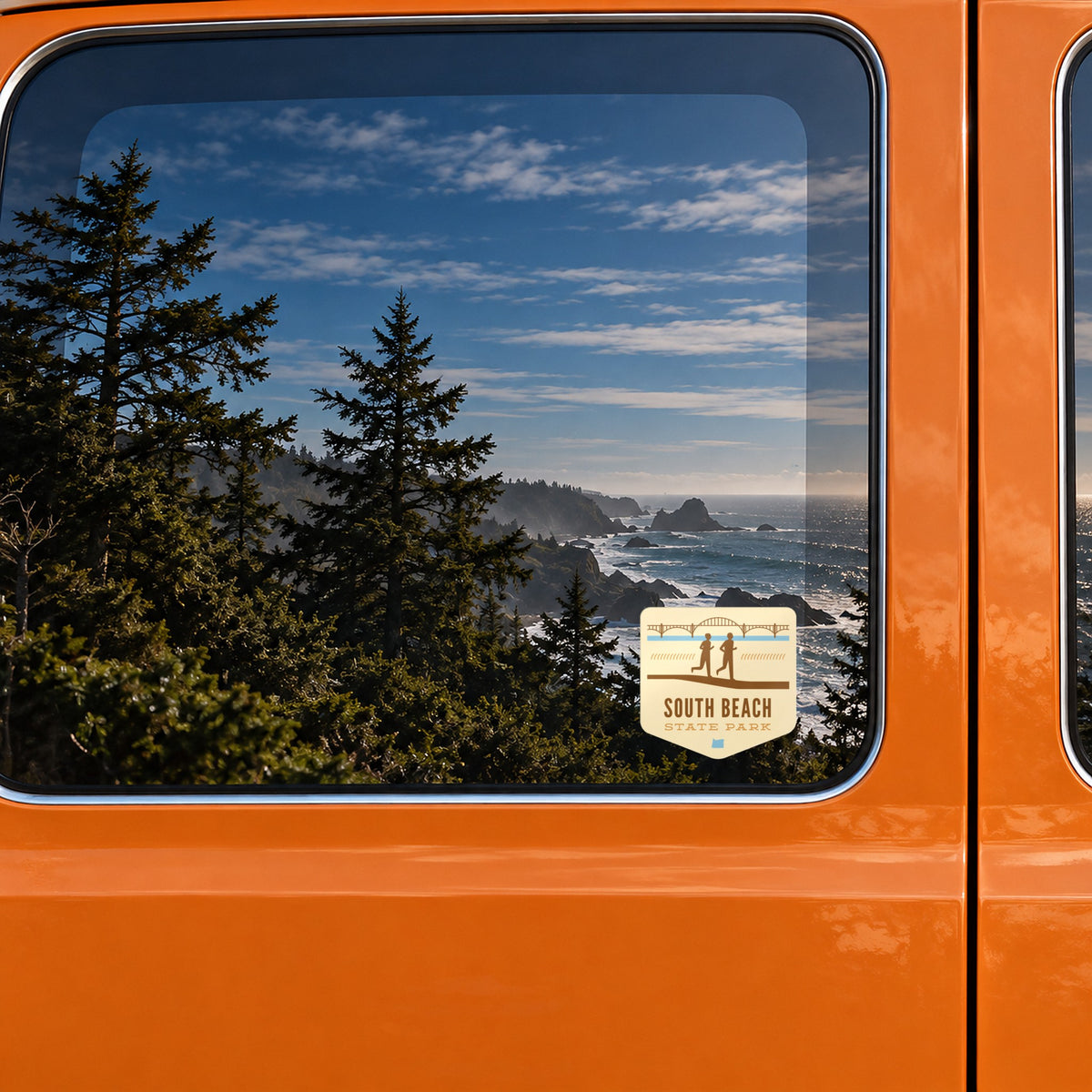 South Beach sticker on the rear window of a van, reflecting a rocky coast with sea stacks