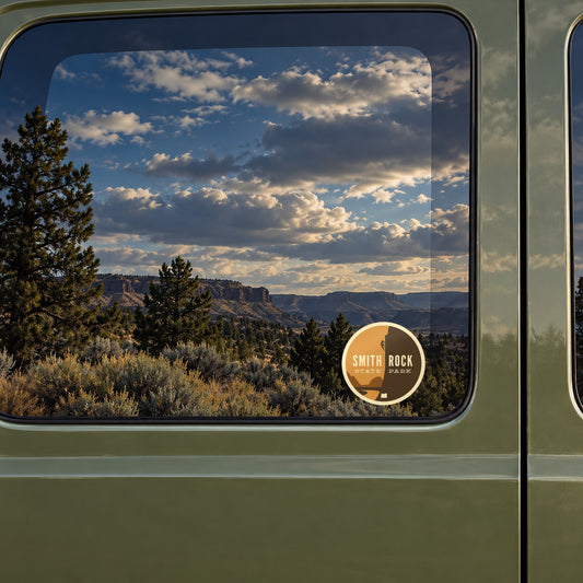 Smith Rock sticker on the rear window of a van, reflecting high-desert rimrock